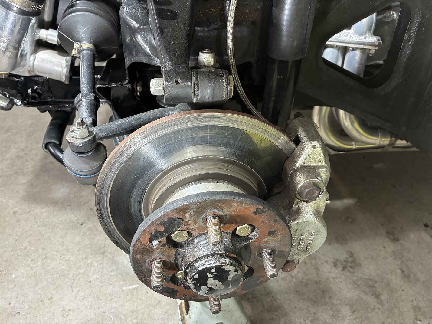 Front brake assembly with Triumph Spitfire rotors and MGB calipers.